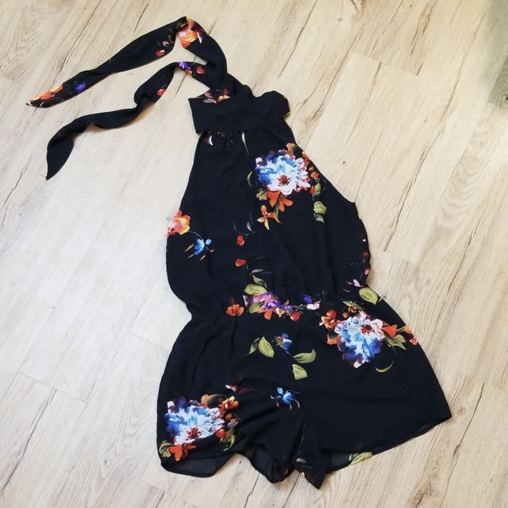 Black floral sleeveless jumpsuit with tie neck